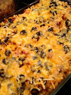 a casserole dish with black olives and cheese