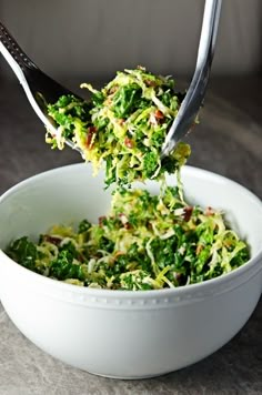 a white bowl filled with shredded broccoli on top of a table