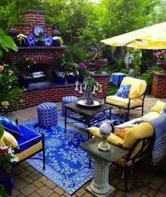 an outdoor living area with blue and yellow furniture