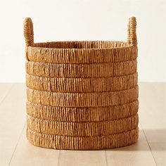 a large woven basket sitting on top of a wooden floor