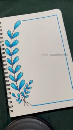 a spiral notebook with blue leaves on it