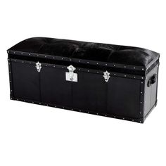 a large black trunk sitting on top of a white floor