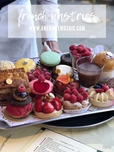 a tray filled with assorted pastries on top of a table