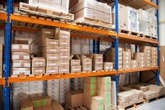 shelves filled with boxes and other items in a warehouse