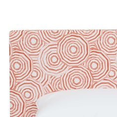 an orange and white headboard with circles on it