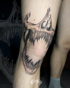 a man's leg with a tattoo on it and an animal skull in the middle