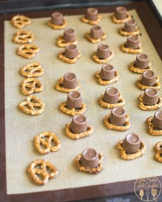 pretzels and pretzels are arranged on a cookie sheet to be baked