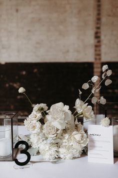 the table is set with white flowers and candles