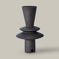 three black vases stacked on top of each other