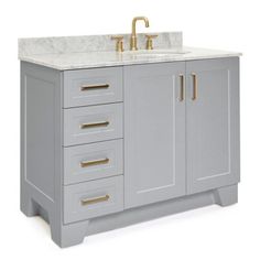 a bathroom vanity with gold handles and drawers