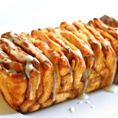 some kind of pastry on a plate with icing and drizzled around it