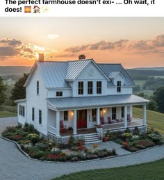 a white house sitting on top of a lush green field next to a forest at sunset