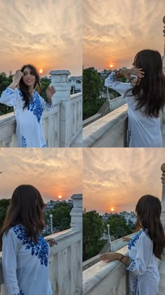 a woman standing on top of a bridge next to the sun in the sky and talking on her cell phone