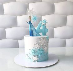 a frozen princess cake with frosting on top