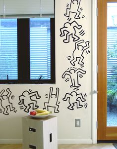 a room with a door, window and wall sticker on the wall in it