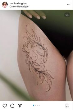 a woman's thigh with a flower tattoo on the side and an image of a fish