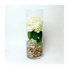 a glass vase filled with rocks and flowers