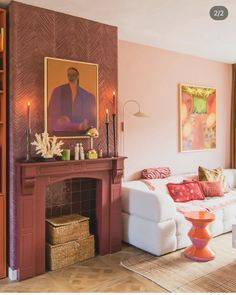 a living room with pink walls and white furniture