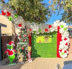 an arch decorated with balloons and christmas decorations