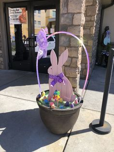 a basket filled with easter eggs sitting on top of a sidewalk