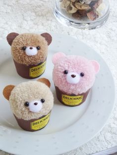 four stuffed animals sitting on top of a white plate