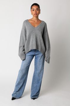 The Elsie sweater features a plunging v-neck in a trending, yet classic, heather grey. Fit is oversized with a cut hemline in the back. Fit chart in photos. V Neck Top Aesthetic, Fall Clothing Inspiration, V-neck Sweater, Fall Sweaters 2024, Grey Knit Outfit, Oversized V Neck Sweater Outfit, Grey V Neck Sweater Outfit, Grey Knit Sweater Outfit, Girls Day Outfit