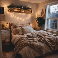 a bed with blankets and lights in a bedroom