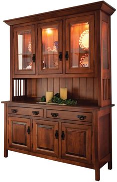 a wooden hutch with glass doors and drawers on it's sides, against a white background