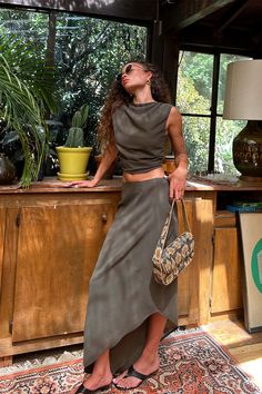 It's easy to say we’re obsessed with the Mila Olive Set, the newest color way of the Mila Set. This olive beauty features a slightly asymmetrical hemline and maxi silhouette, making it a must-have addition to your wardrobe. This top pairs perfectly with the Mila Olive Maxi Skirt and an olive martini in hand. Trust us, you’re going to need both colors—the olive and the leopard—to keep your style game strong all season long. Olive Martini, Fall Bottoms, Party Bottoms, Concert Dresses, Denim And Diamonds, Dresses Date Night, Bridal Tops, Beauty Features, Fall Wedding Guest Dress