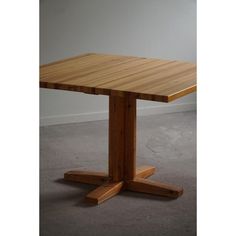 a wooden table sitting on top of a carpeted floor