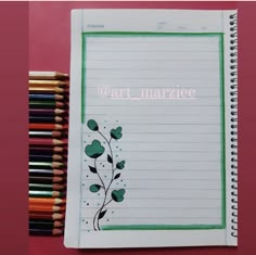 a notebook with the words marzice written on it next to colored pencils