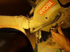 a man is using a circular saw to cut through the side of a piece of wood