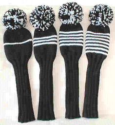 four black and white knitted mittens with pom - poms on them