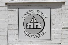 a sign on the side of a building that says lake's folly vineyards