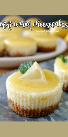 lemon cheesecakes are sitting on a table with other desserts in the background