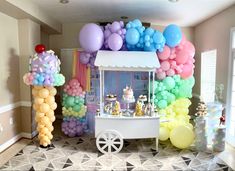 an ice cream cart with balloons on the front and sides, along with other decorations