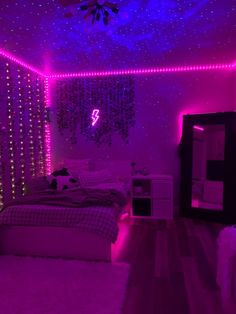 a bedroom with purple lights on the ceiling