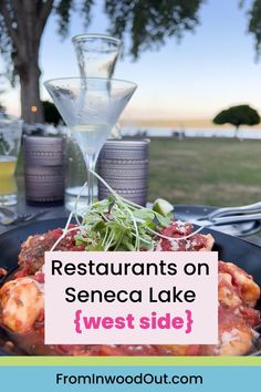 An outdoor restaurant table set with food and cocktails, with a blurred view of a lake in the background. Catskills Ny, Smoked Ribs, Wine Trail, Homemade Donuts