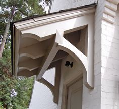 an arch on the side of a white house