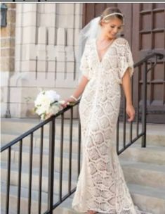 a woman in a wedding dress standing on stairs