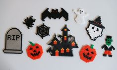 halloween decorations made out of perler beads on a white surface, including pumpkins and ghostes