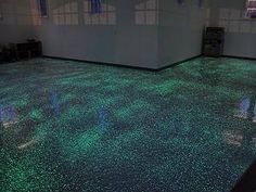 an empty room with green lights on the floor