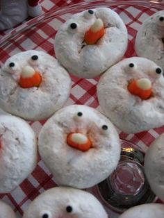 snowmen made out of doughnuts sitting on a red and white checkered tablecloth