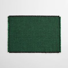 a green piece of cloth on a white surface