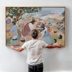 a man standing in front of a large painting