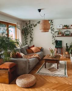 a living room filled with furniture and lots of plants