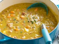 a blue pot filled with soup on top of a table