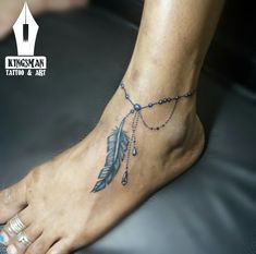 a woman's foot with a tatoo on it and a chain hanging from the ankle