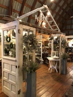 a room filled with lots of furniture and decor on top of a wooden floor covered in lights