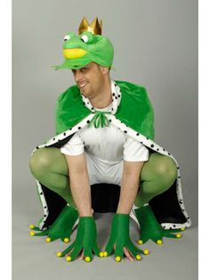 a man in a frog costume sitting on the ground with his legs crossed and feet spread out